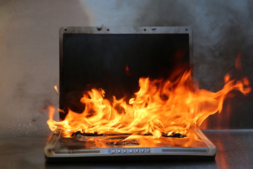 bigstock Laptop Damage Laptop on fire 255828553